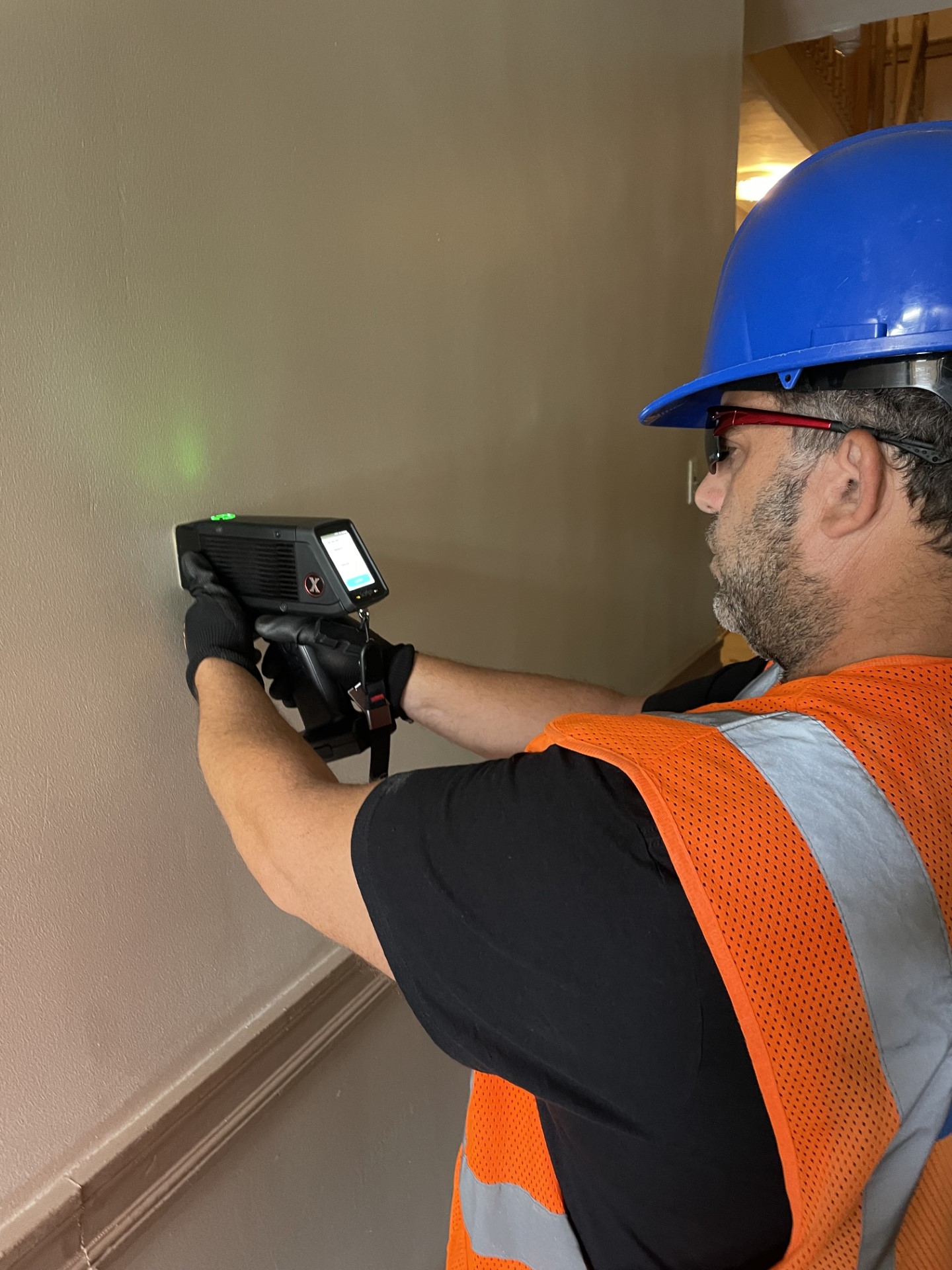 A Worker Operating an XRF Gun